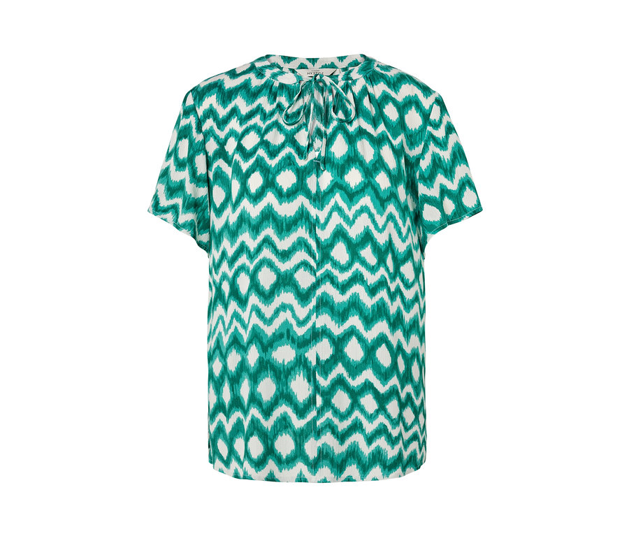 Weisse Tunika-Bluse mit grünem Muster.