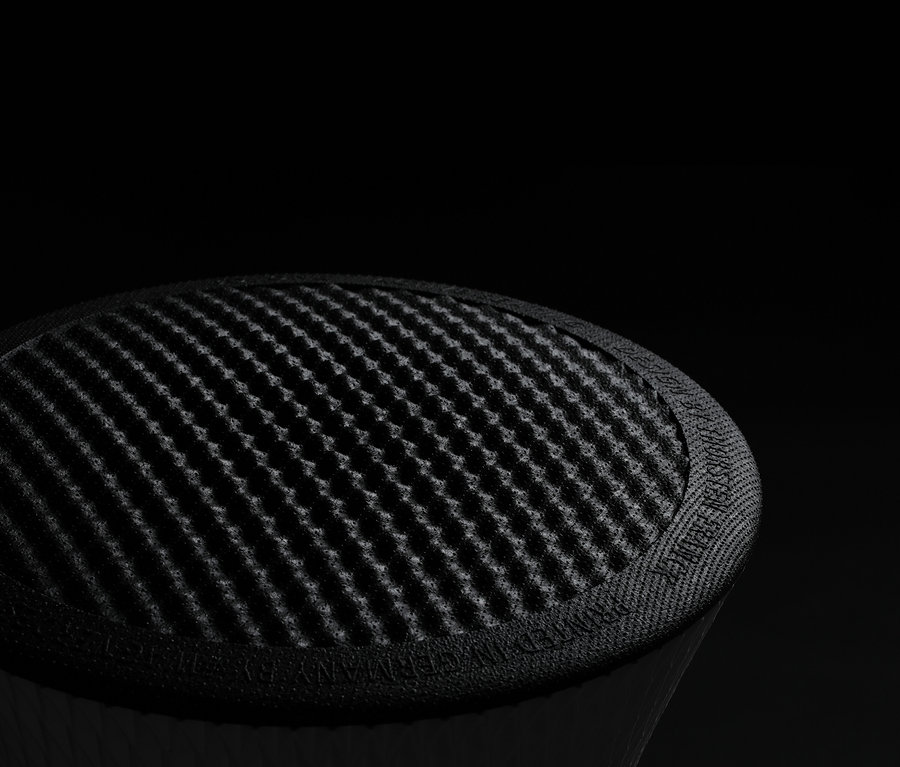 Nahaufnahme eines runden, schwarzen Objekts mit einem diagonal gerasterten Muster auf der Oberseite.