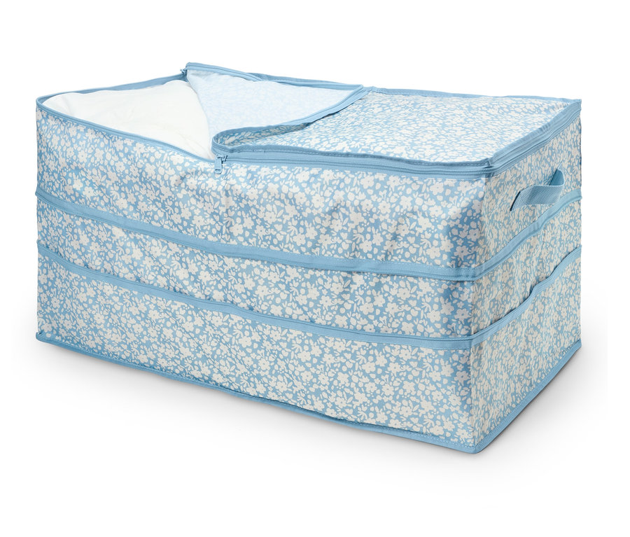Eine blaue Blumenmuster-Aufbewahrungsbox mit Reißverschluss, teilweise geöffnet, das ein weißes Tuch im Inneren zeigt.