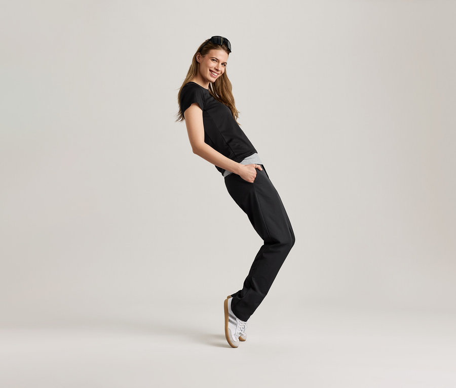 Frau posiert in schwarzem Sportshirt.