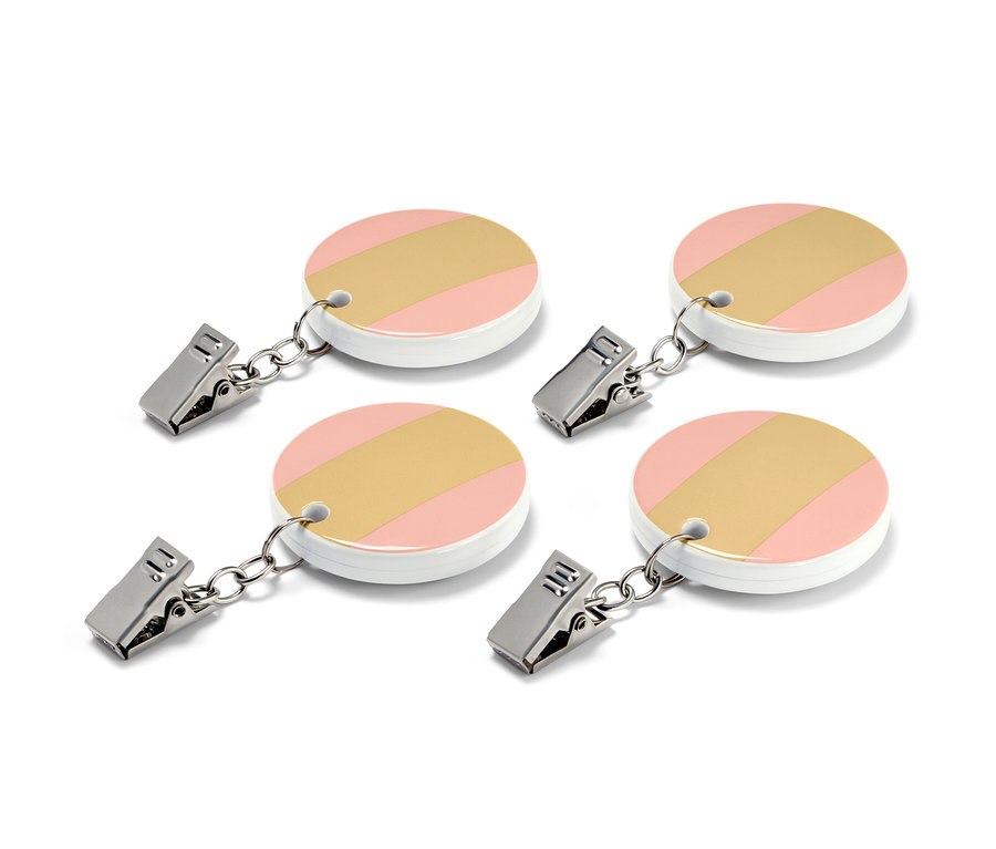 Vier Tischdeckenhalter, je mit Clip, rundem Design in Rosa, Weiß und Gold.