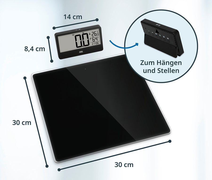 Schwarze digitale Personenwaage (30x30 cm) mit separatem Display (14x8,4 cm), das Gewicht, Temperatur, Luftfeuchtigkeit und Uhrzeit anzeigt und zum Hängen oder Stellen geeignet ist.