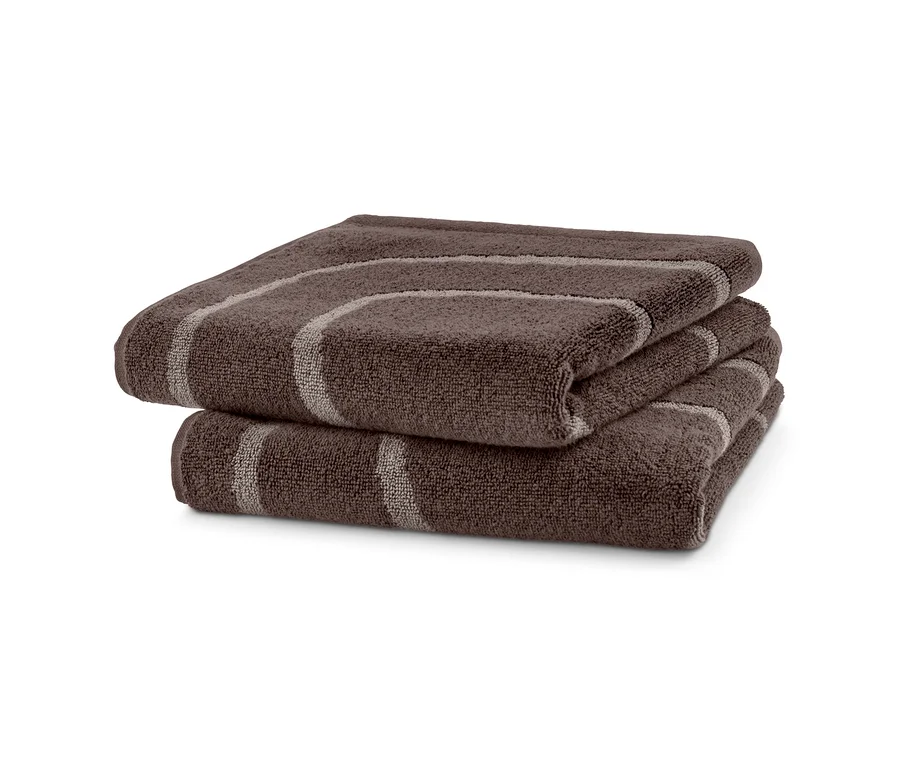 Zwei braune Jacquard-Handtücher liegen gefaltet übereinander.