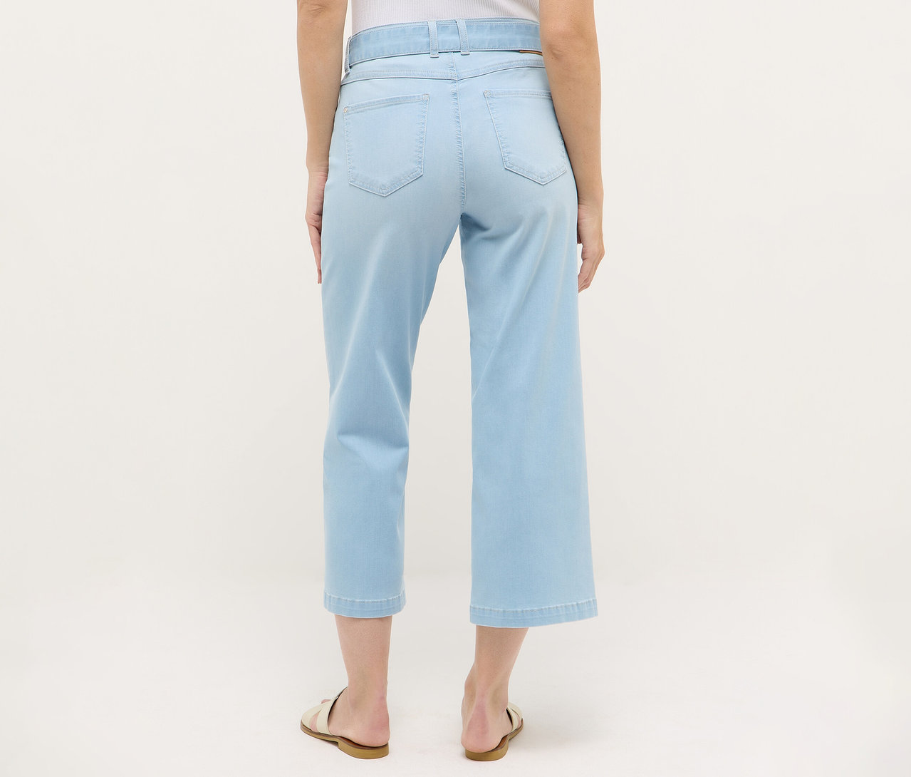 Rückansicht einer Frau, die Angels Denim »Linn City« cropped, bleached blue Jeans und Sandalen trägt.