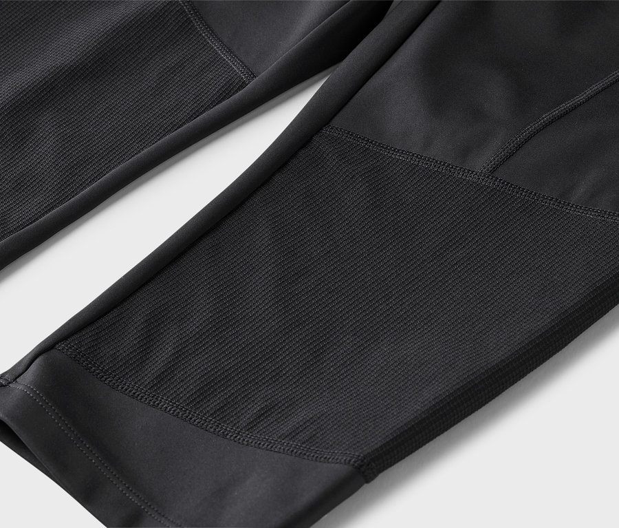 Nahaufnahme von schwarzen Leggings mit strukturierten Einsätzen.