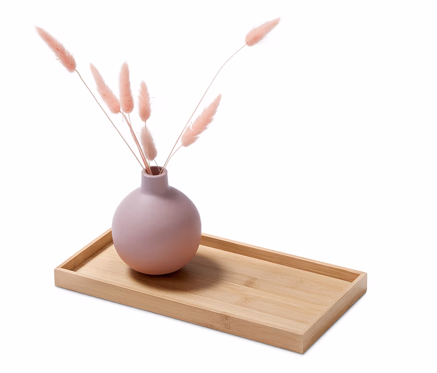Dekoratives Tablett mit rosa Vase und Federn.