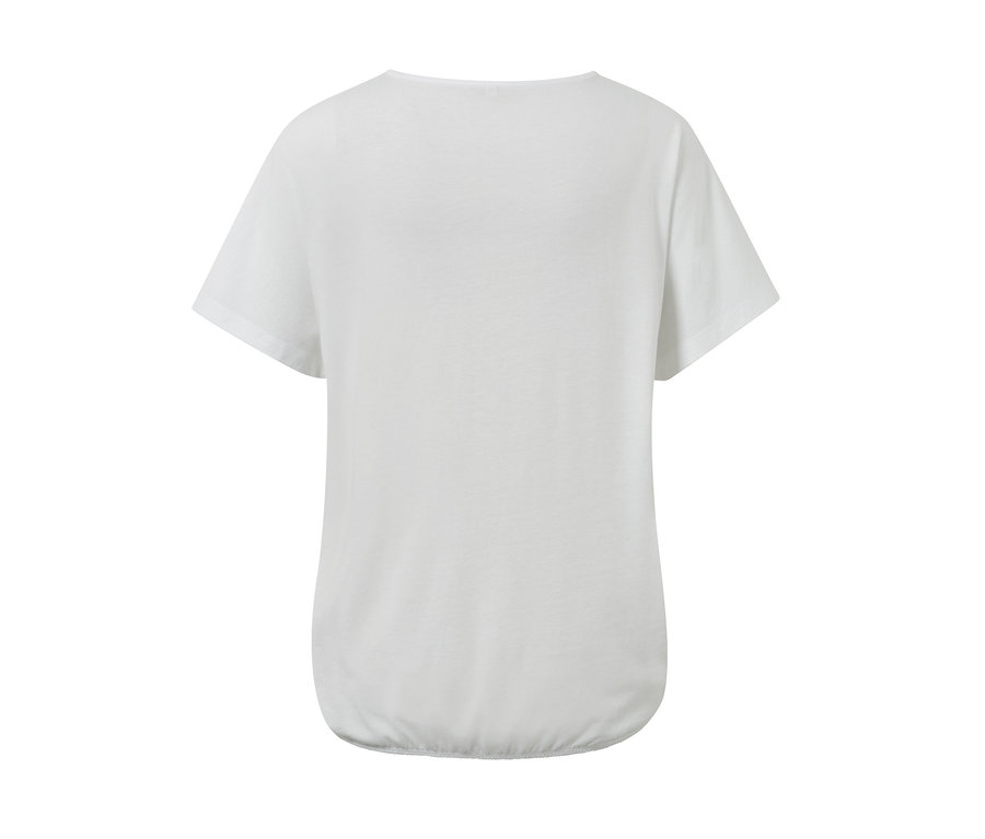 Detailansicht der Rückseite eines weißen Blusenshirts mit Stickerei.