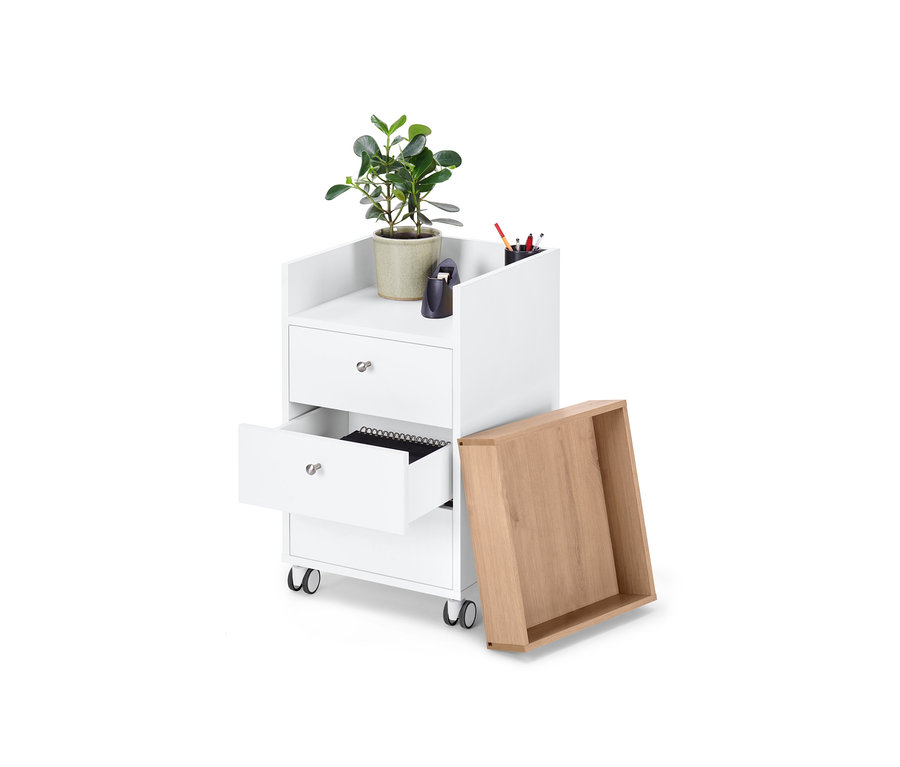 Weißer Rollcontainer mit Schubladen, eine Schublade ist geöffnet, daneben steht eine Schublade aus Eichenholz, oben steht eine Pflanze im Topf.