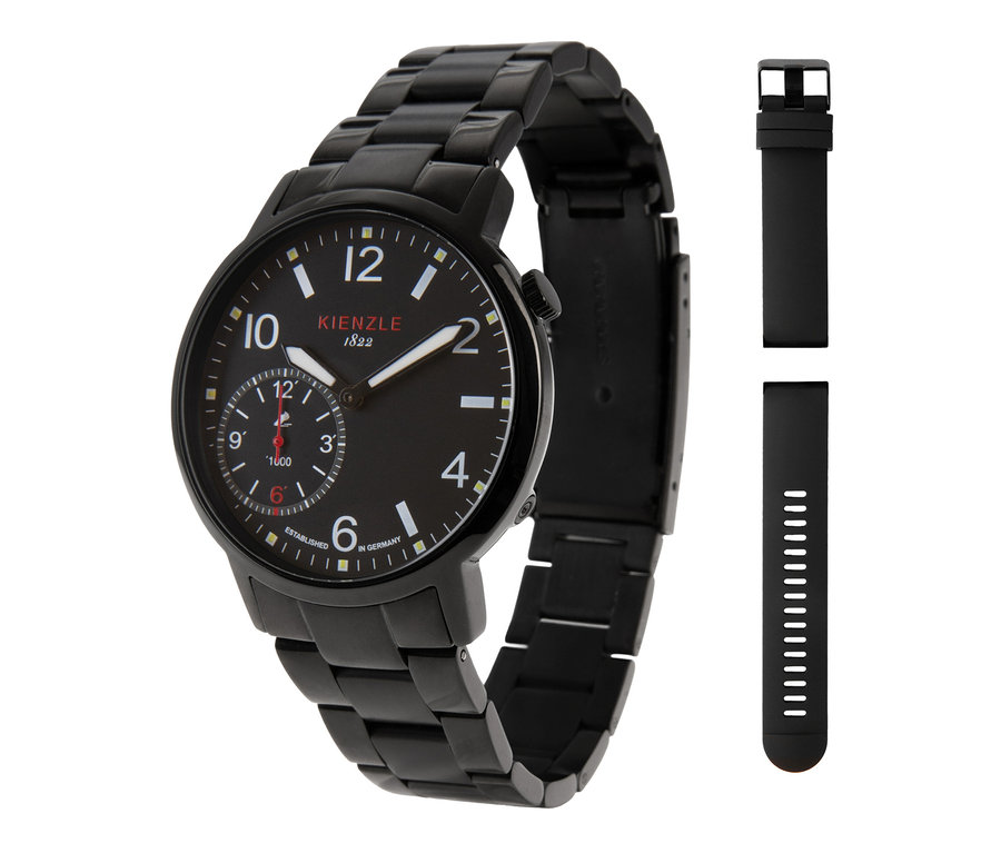 Eine schwarze Uhr mit schwarzem Metallarmband und schwarzem Zifferblatt mit weißen Ziffern, Markierungen und einem Hilfszifferblatt. Daneben sind zwei zusätzliche schwarze Kautschukarmbänder abgebildet.