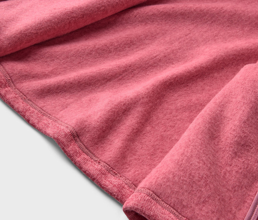 Nahaufnahme eines rosafarbenen Fleece-Stoffes mit Saum und Reißverschluss.