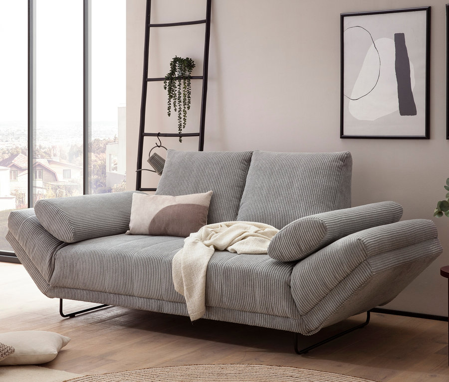Graues DOMO collection Daybed »Molde Leif55« mit Kissen und Überwurf im Wohnzimmer.