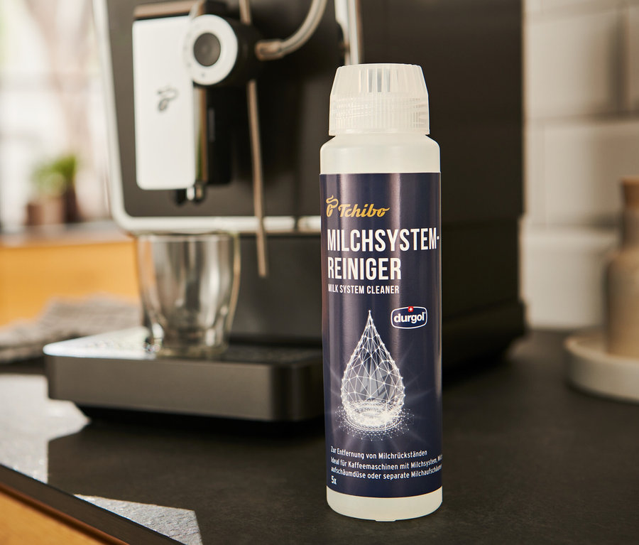 durgol® Milchsystem-Reiniger	, 250 ml steht neben einer Kaffeemaschine.