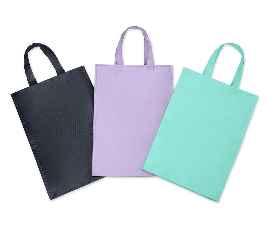 Drei Stofftaschen mit Henkeln in Schwarz, Lila und Türkis.