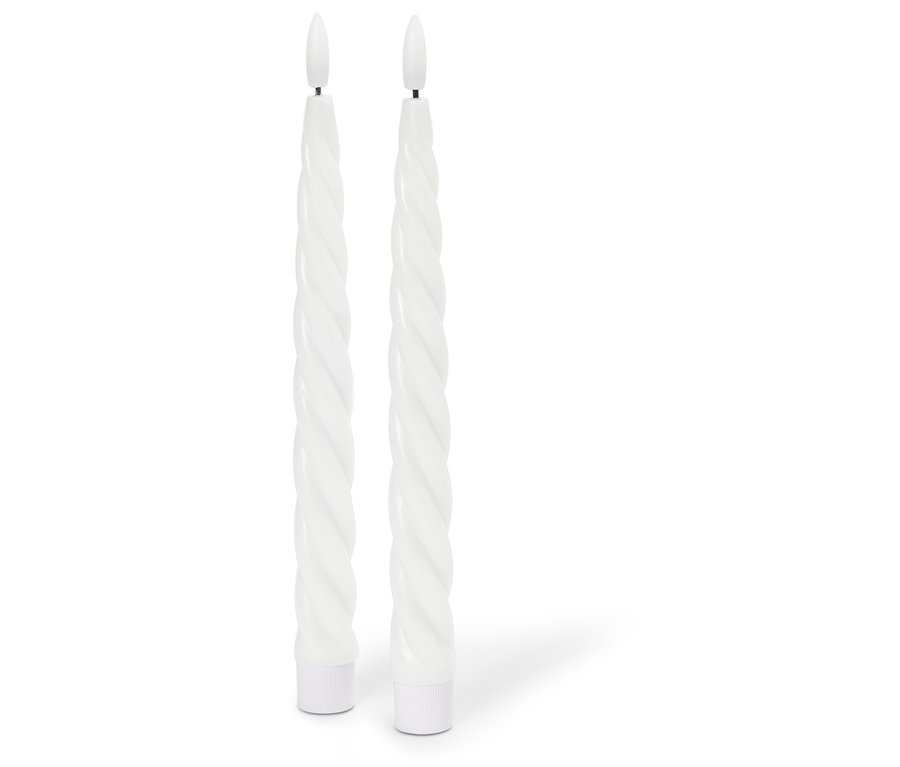 Zwei gedrehte, weiße LED-Kerzen stehen auf einem weißen Untergrund.