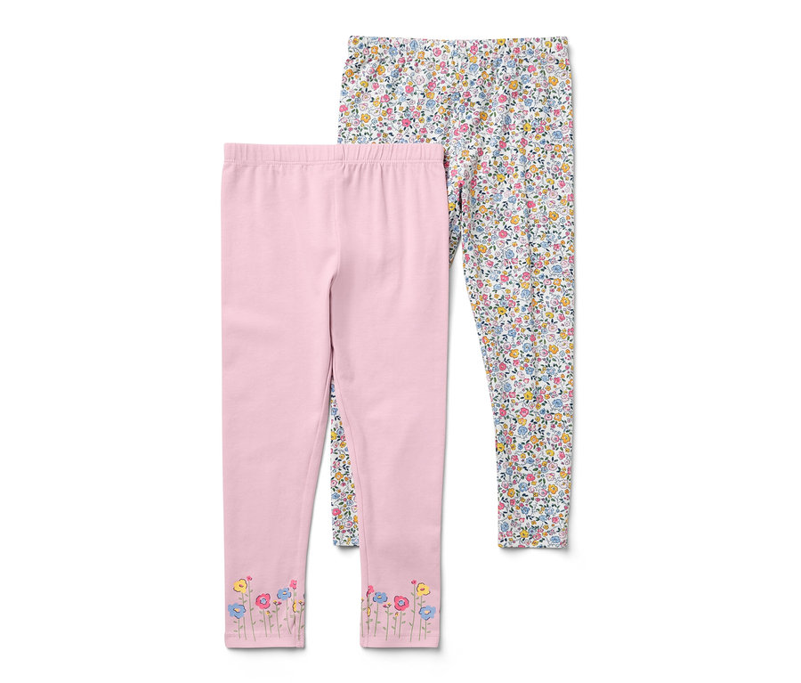 Zwei Kinder-Leggings: eine rosa mit Blumen an den Beinenden, eine weiße mit kleinen Blumenmustern.