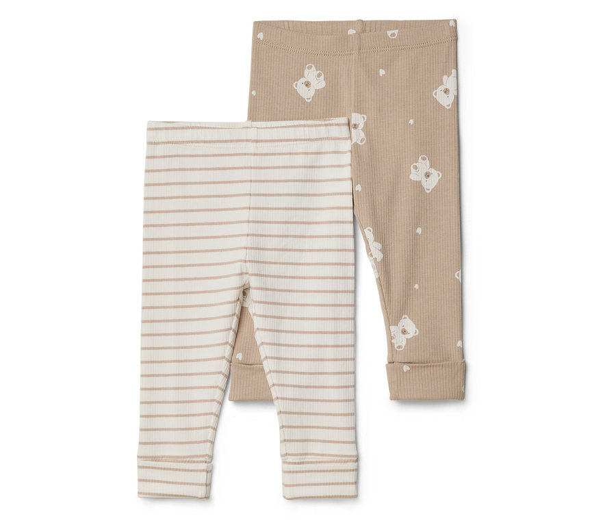 Zwei Babyhosen liegen übereinander. Eine ist beige-weiß gestreift, die andere ist beige mit weißen Teddybären.