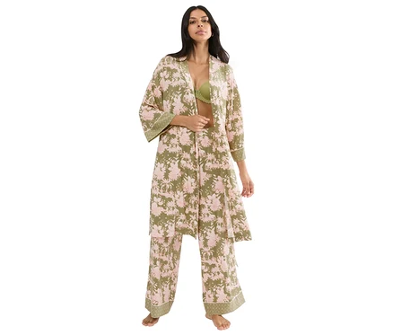 Frau in offenem Triumph Aura Spotlight Robe und passender Hose mit rosa Blumenmuster auf Olivgrün, grüner BH sichtbar.