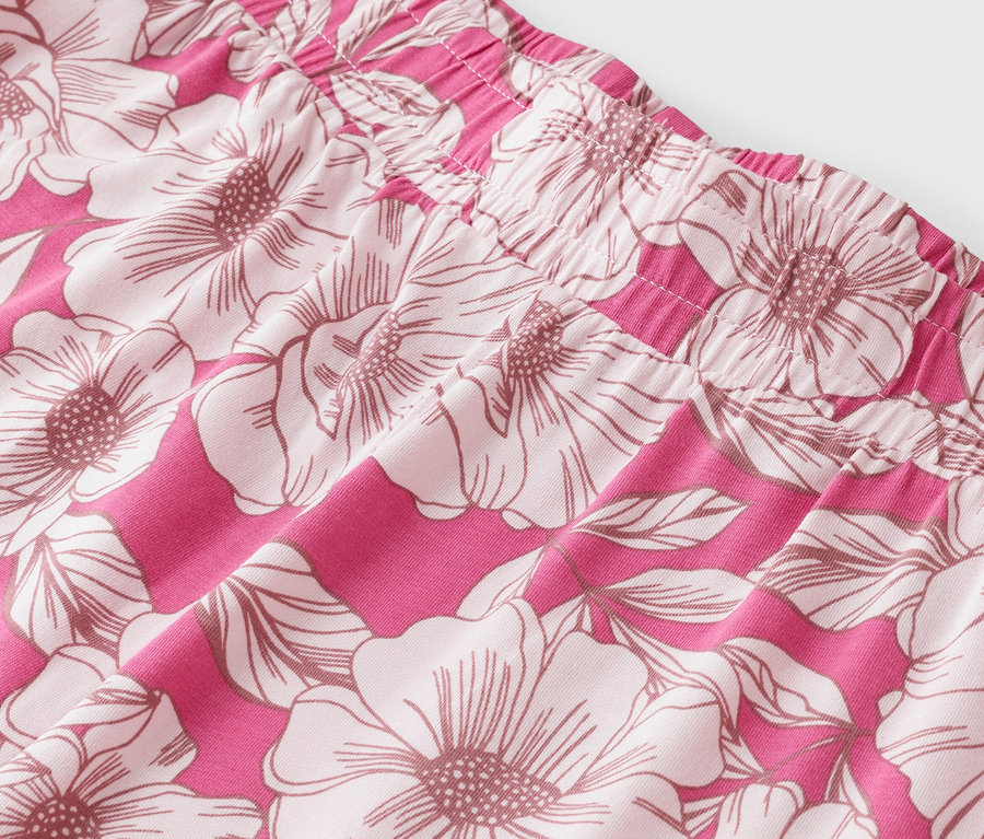 Nahaufnahme eines pinkfarbenen Stoffes mit großem Blumenmuster.