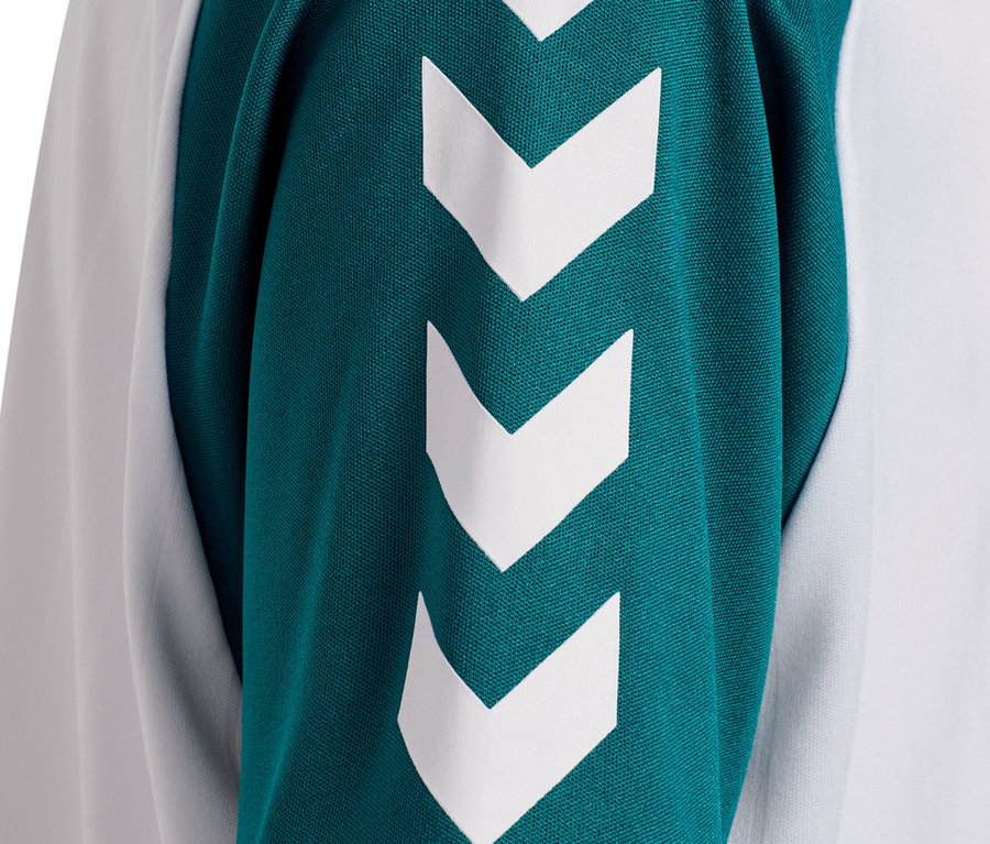 Detailaufnahme eines Ärmels eines weiß-grünen Oberteils mit weißen Winkelmotiven.