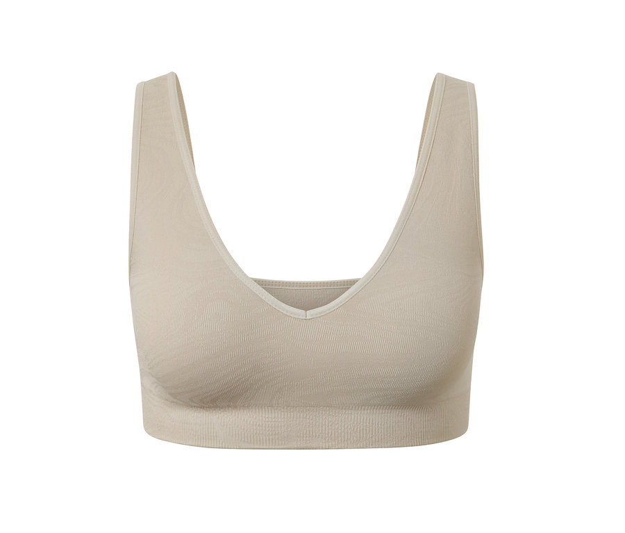 Ein nahtloses Sport-Bustier in Beige.