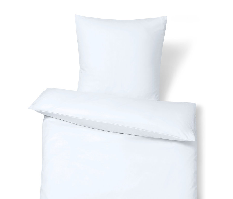 Detail einer weißen Bettwäsche mit Kissen oben.