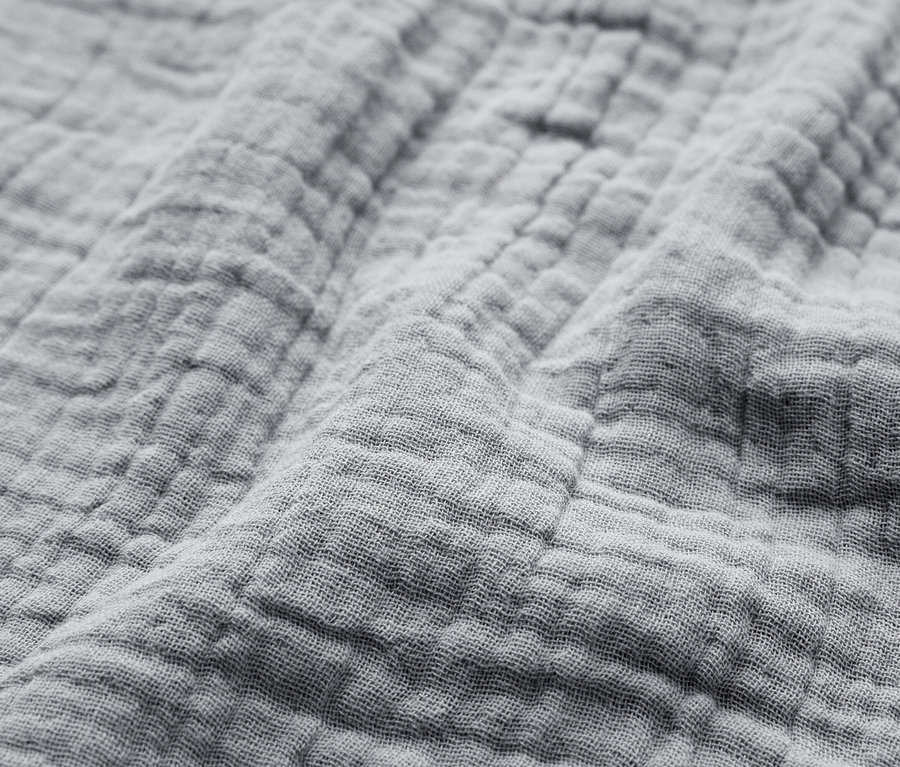 Nahaufnahme eines grauen, strukturierten Stoffes