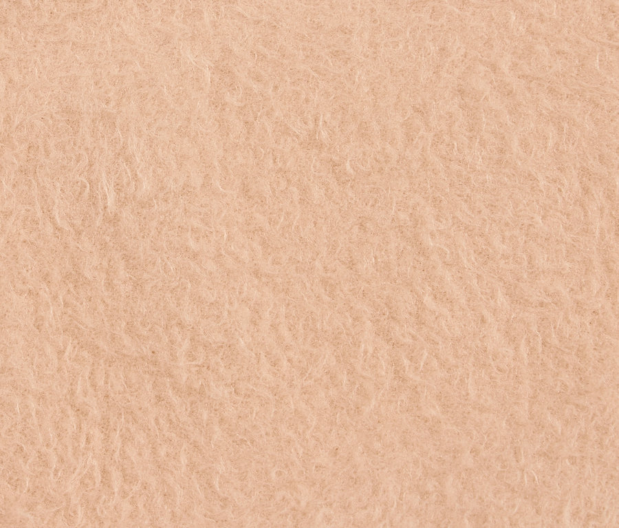 Nahaufnahme einer pfirsichfarbenen, zotteligen Textur.