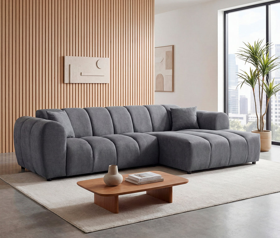 Graues Ecksofa »Loftwave« mit Longchair rechts und 2-Sitzer links im Wohnzimmer.