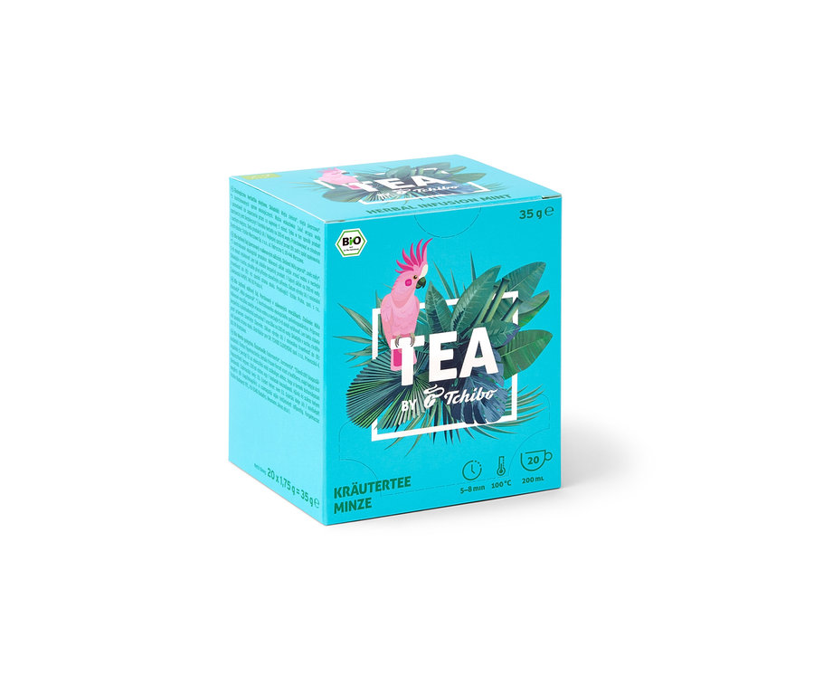 Packung TEA by Tchibo Bio Kräutertee Minze mit Kakadu und tropischen Blättern.