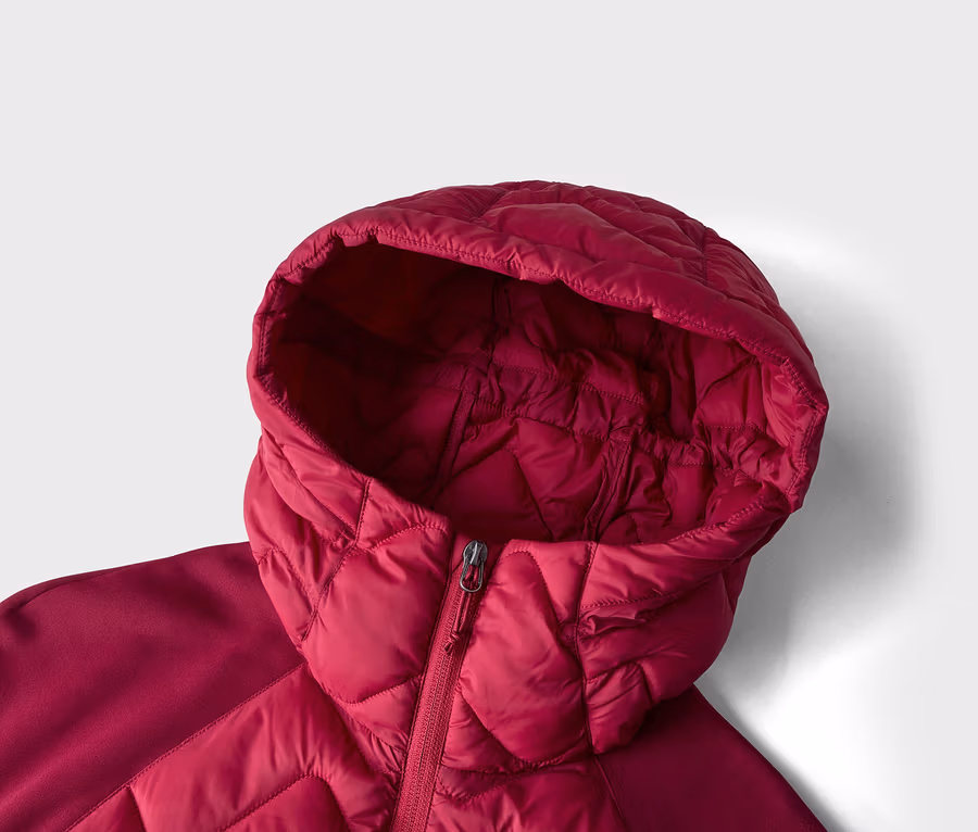 Nahaufnahme einer roten Steppjacke mit Kapuze, die den teilweise geschlossenen Reißverschluss zeigt. Die Jacke hat ein rautenförmiges Steppmuster am Körper und an der Kapuze, mit glatten Stoffeinsätzen an den Schultern.
