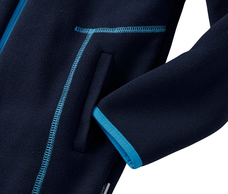 Detailaufnahme einer dunkelblauen Fleecejacke mit azurblauen Abschlüssen an Tasche und Ärmel.