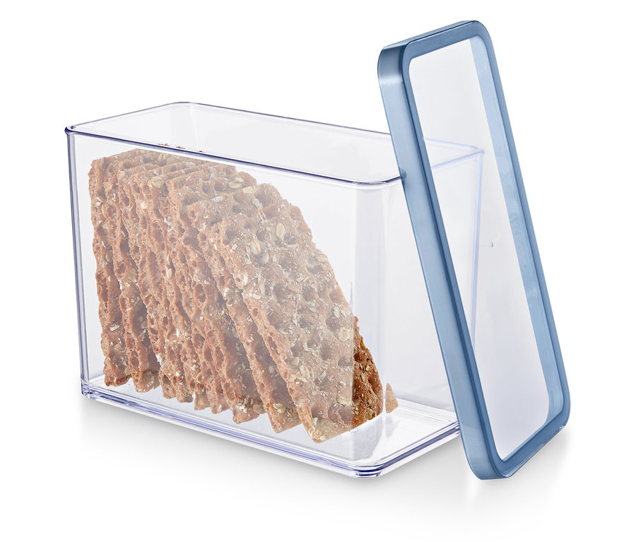 Eine durchsichtige Vorratsdose mit blauem Rand gefüllt mit Vollkorncrackern.