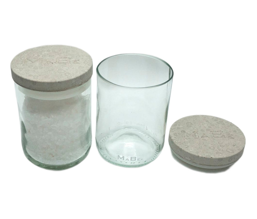 Ein ca. 12 cm großes Vorratsglas mit Deckel, gefüllt mit weißen Kügelchen, neben einem leeren Glas mit Deckel.
