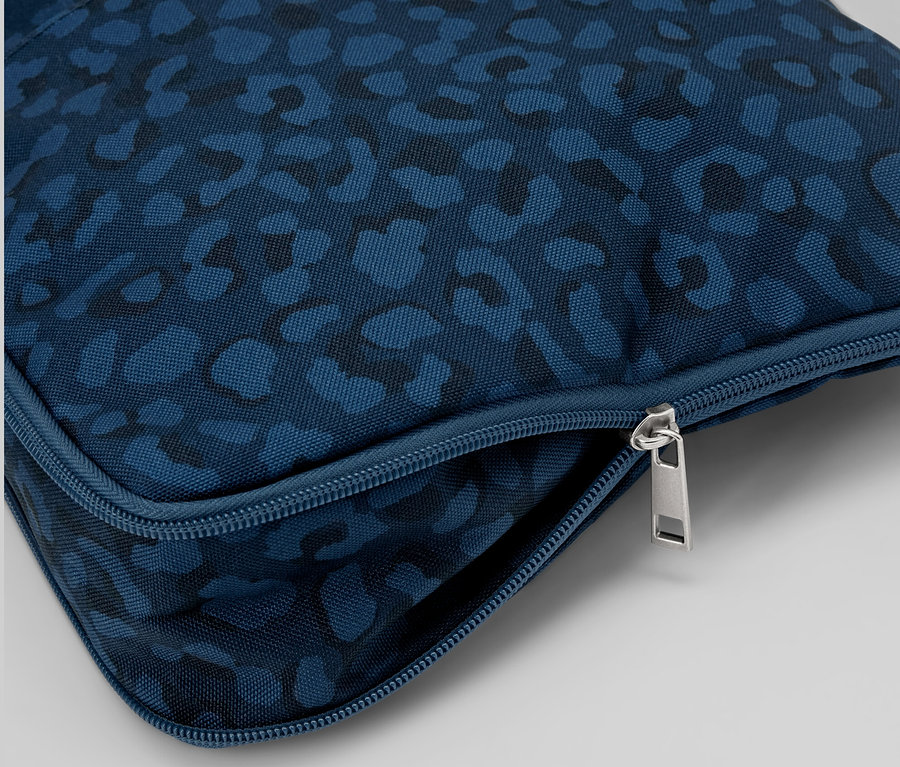 Detailaufnahme einer blauen Sicherheits-Umhängetasche mit Muster und silbernem Reißverschluss.