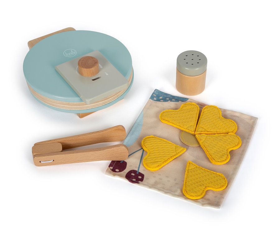 Blauer Holz-Waffelautomat von small foot Waffeleisen-Set »tasty« mit Holzzange, gelben Waffeln und Streuer auf einer Serviette.