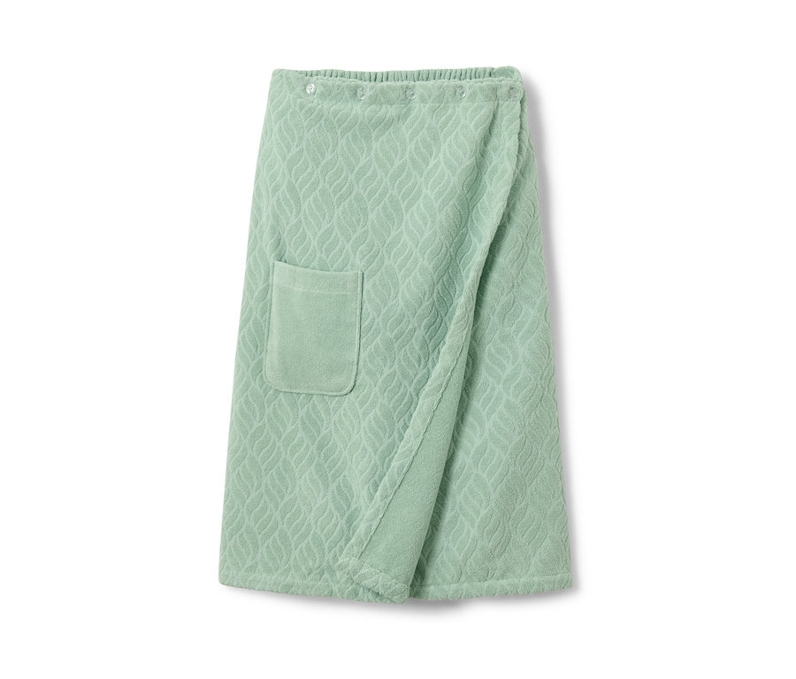 Ein grüner Sauna-Kilt mit Tasche und Muster.