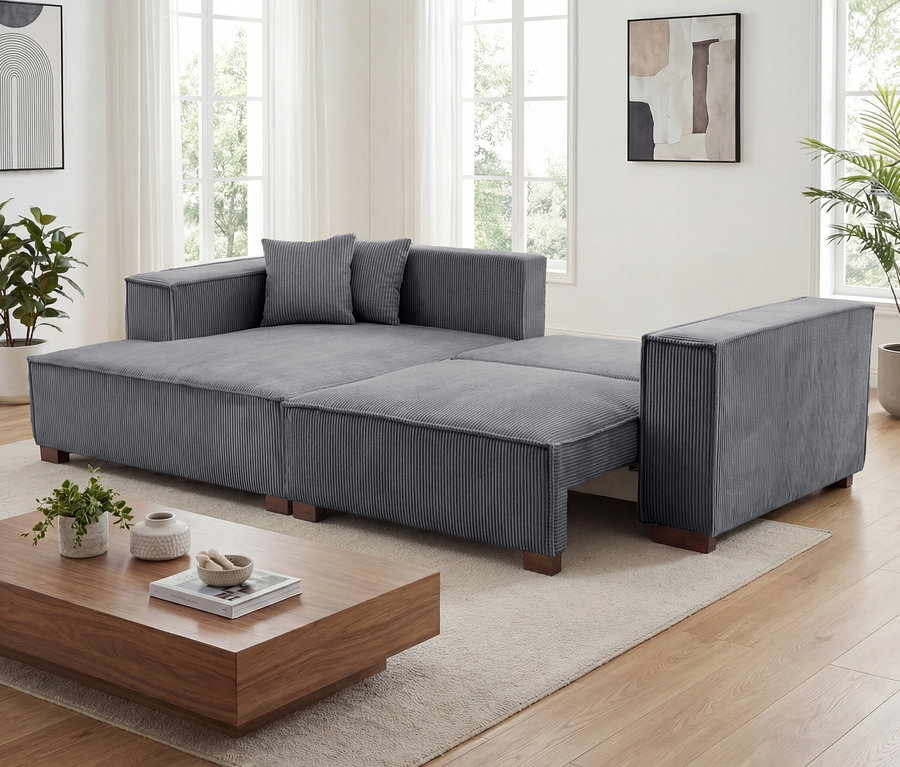 Ein graues Sofa 2-Sitzer mit Auszugsbett rechts, Longschair links »Cumello« steht im Wohnzimmer.