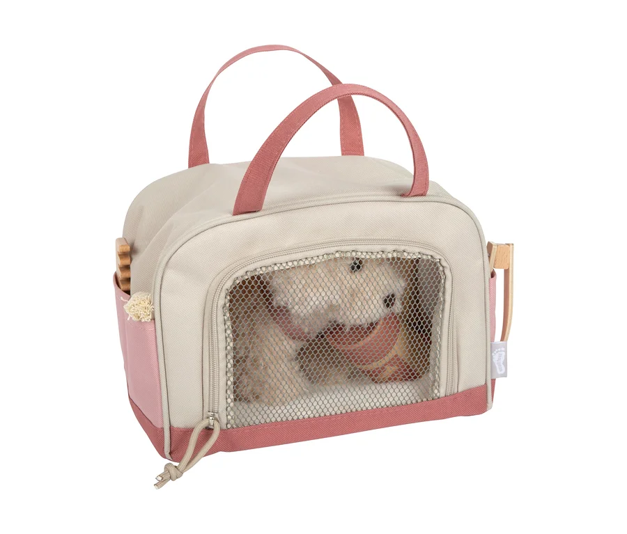 small foot Plüschhund mit Tasche und Pflege-Set: Eine beige-rosafarbene Tragetasche mit einem Plüschhund und Pflegezubehör in den Seitentaschen.