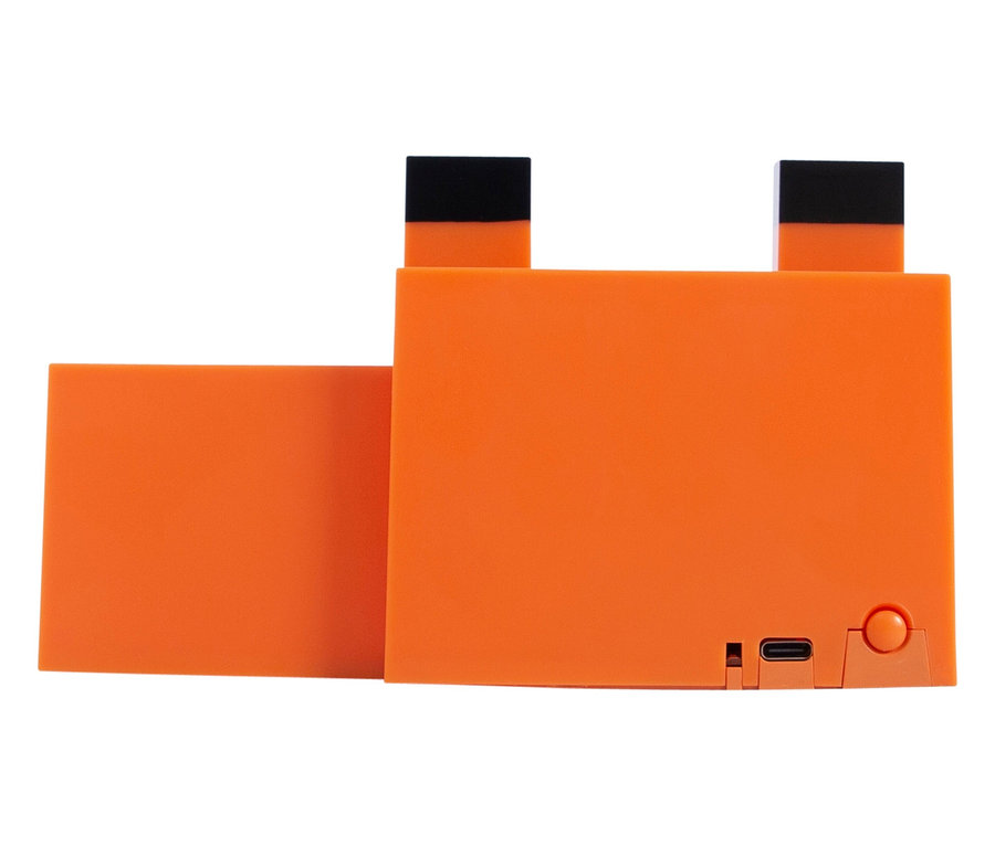 Nahaufnahme eines orangefarbenen Objekts mit schwarzen Akzenten und einem Anschluss auf der Rückseite.