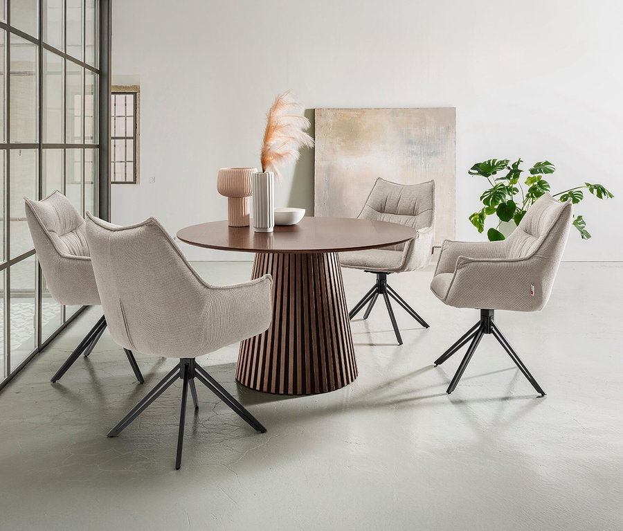 Vier DeVries »Ginosa« Diningsessel, drehbar, in Beige stehen um einen runden Holztisch.